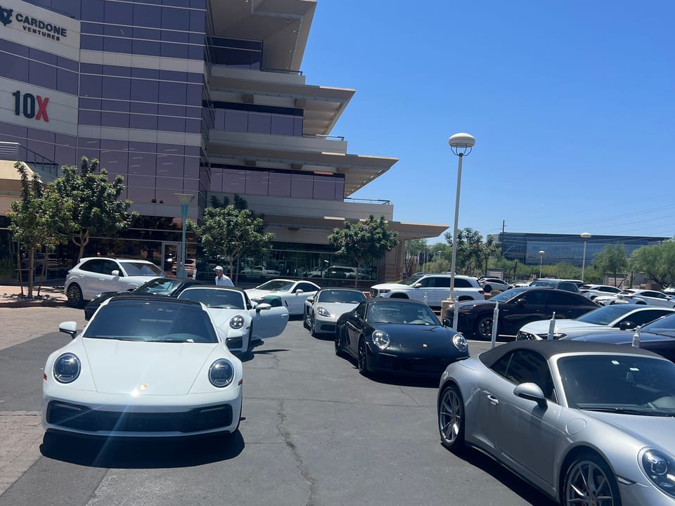A row of Porsches staged by Royal Valet outside the Cardone Ventures building for a corporate event